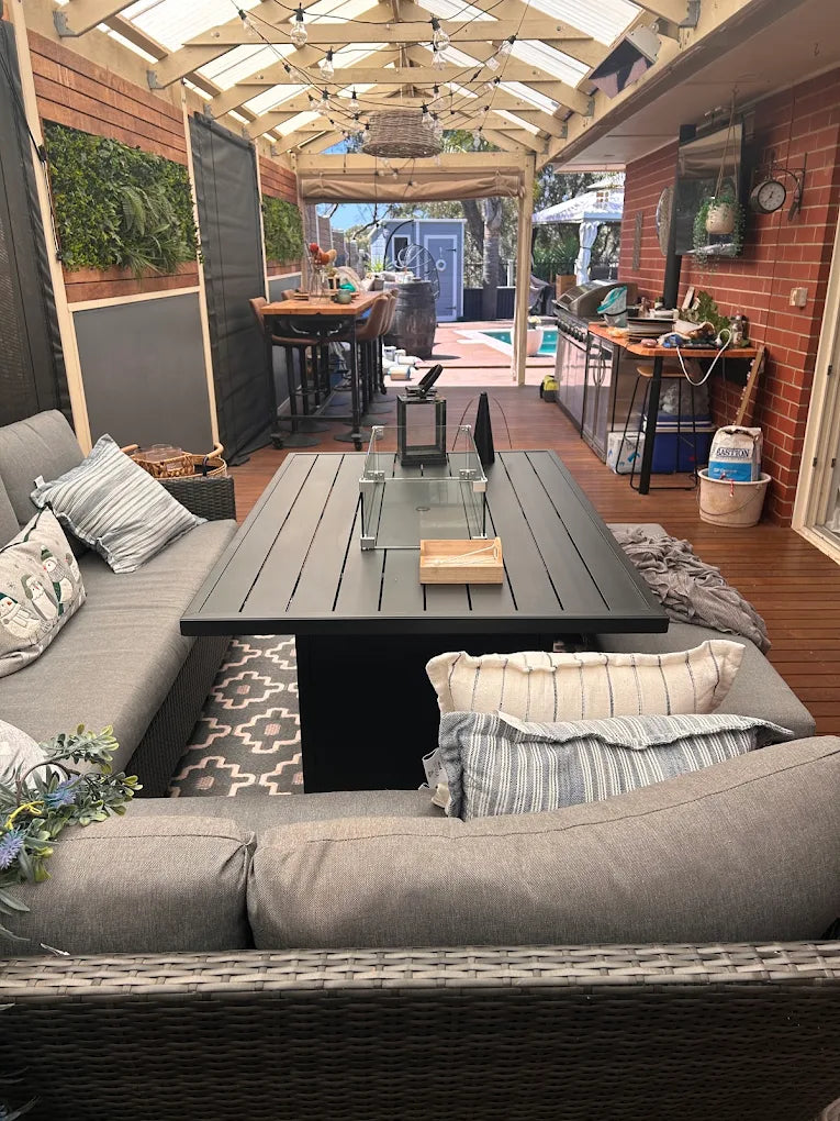 Outdoor Kitchen and Furniture patio dining gas fire pit table with a modern design and seating area setup in a backyard.