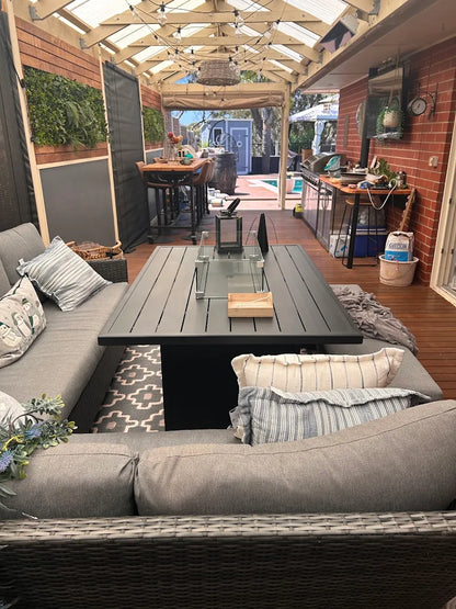 Outdoor Kitchen and Furniture patio dining gas fire pit table with a modern design and seating area setup in a backyard.