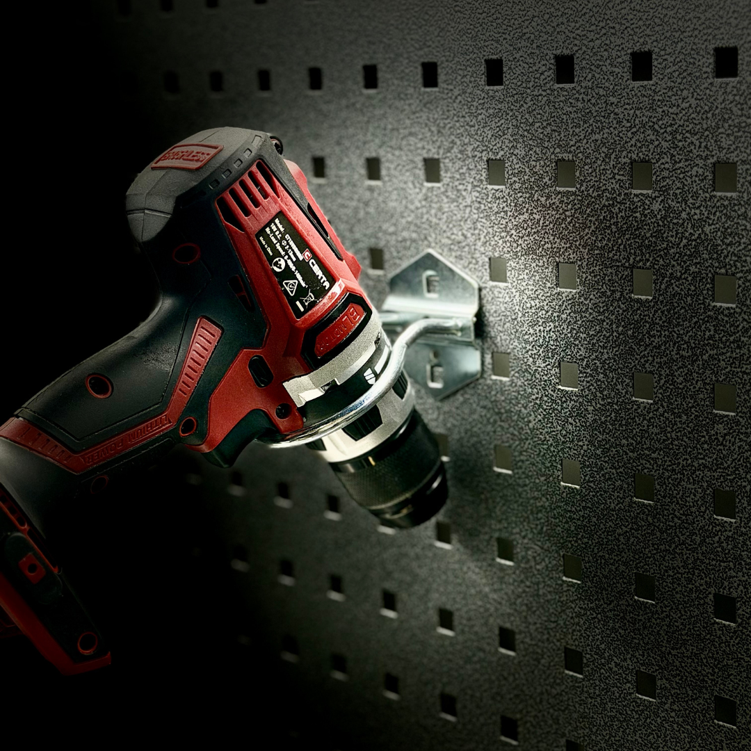 a drill hang on the round pegboard hooks